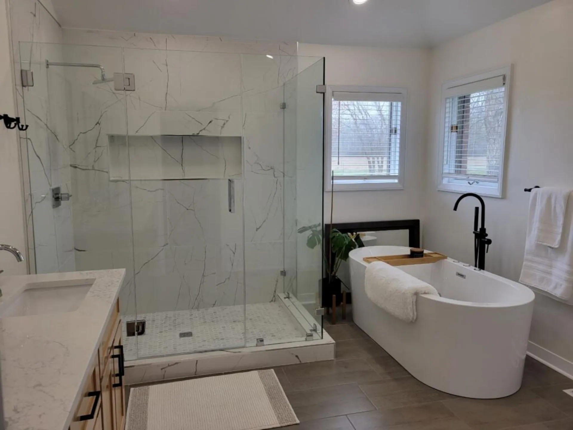 Luxury bathroom remodel in Chesapeake with frameless glass shower and freestanding soaking tub