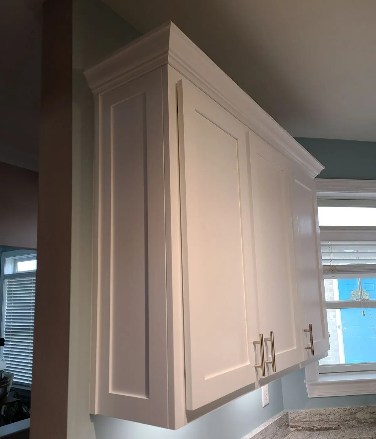 Tall white kitchen cabinets with crown moldine