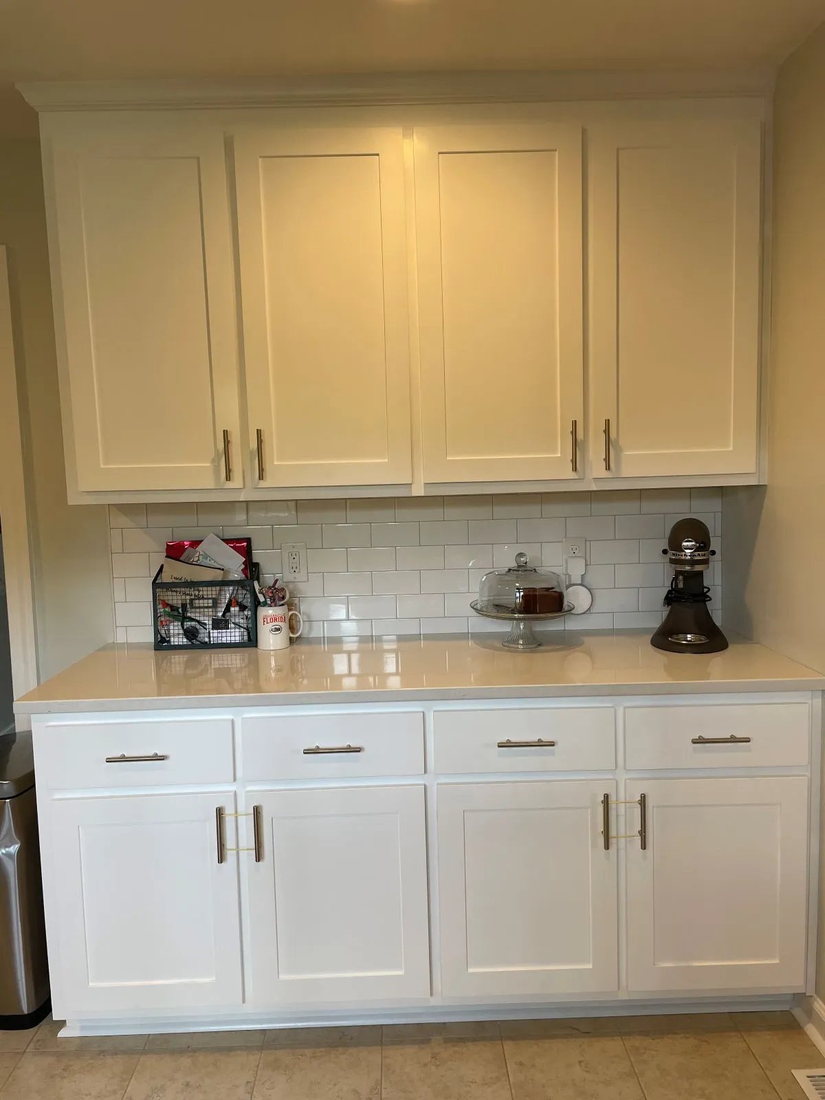 Mudroom cubbies with white cabinetry, bench seat, and coat hooks