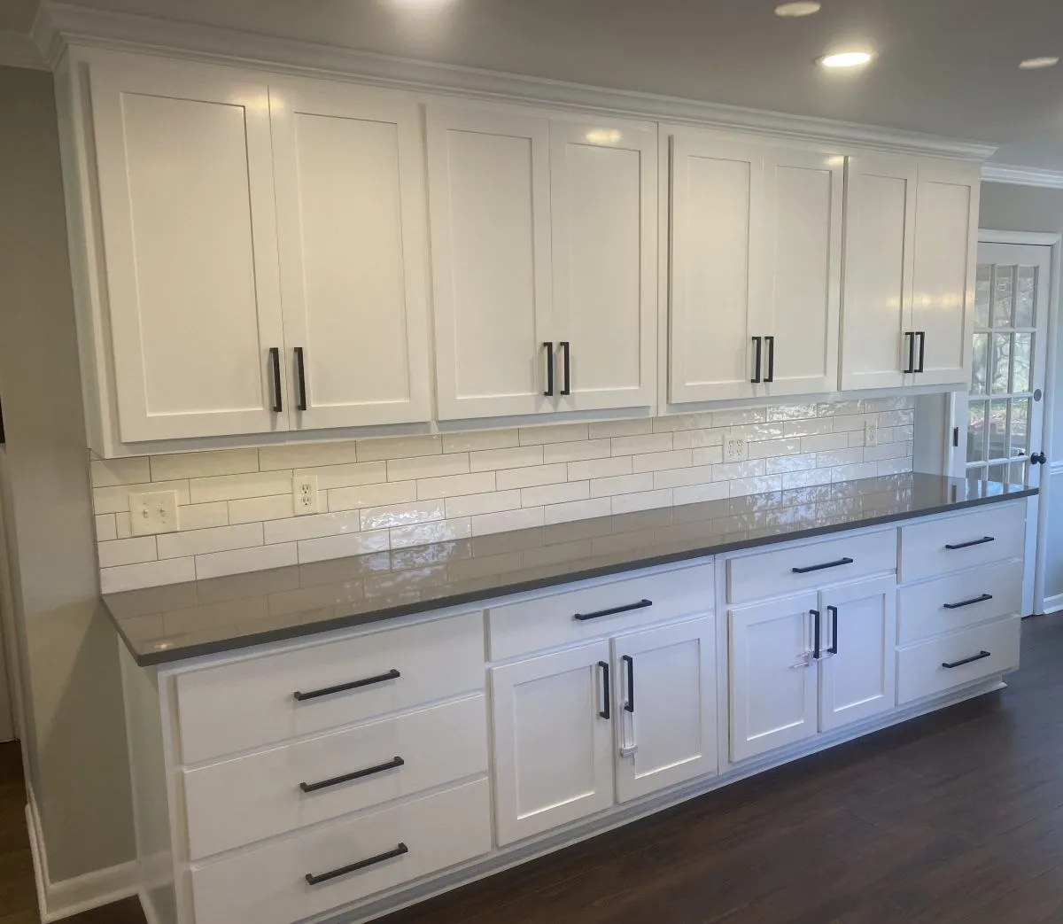 Built-in media wall with open shelving, center TV niche, and shaker-style doors
