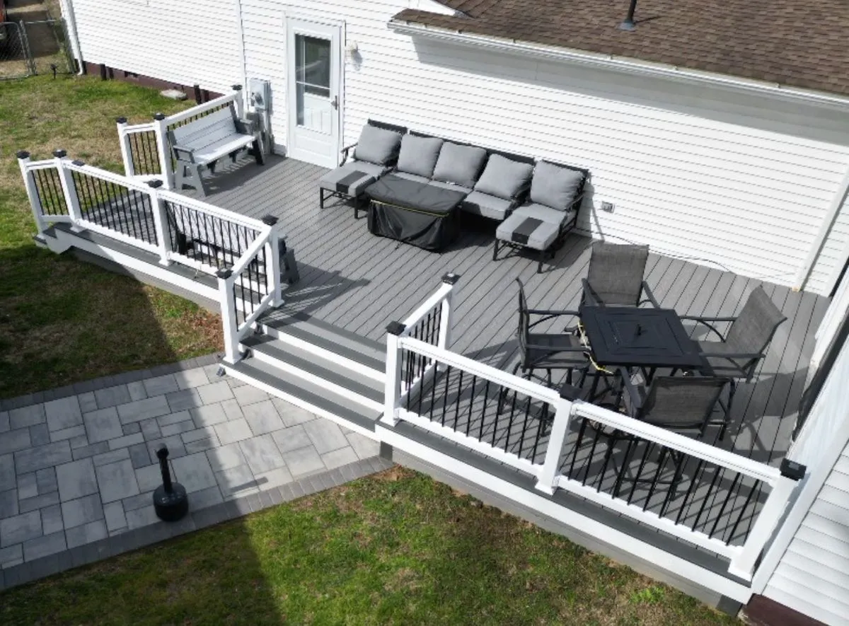 Modern composite deck with white railings and gray boards, built for low maintenance outdoor living
