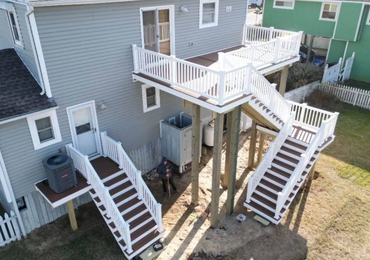 Tall elevated wood deck with double staircases built on a coastal home in Virginia Beach