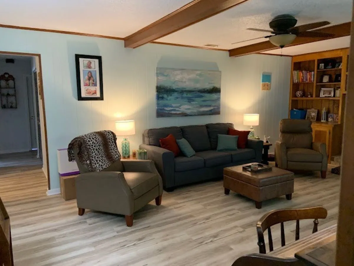 Luxury vinyl plank flooring installed in living room with custom trim