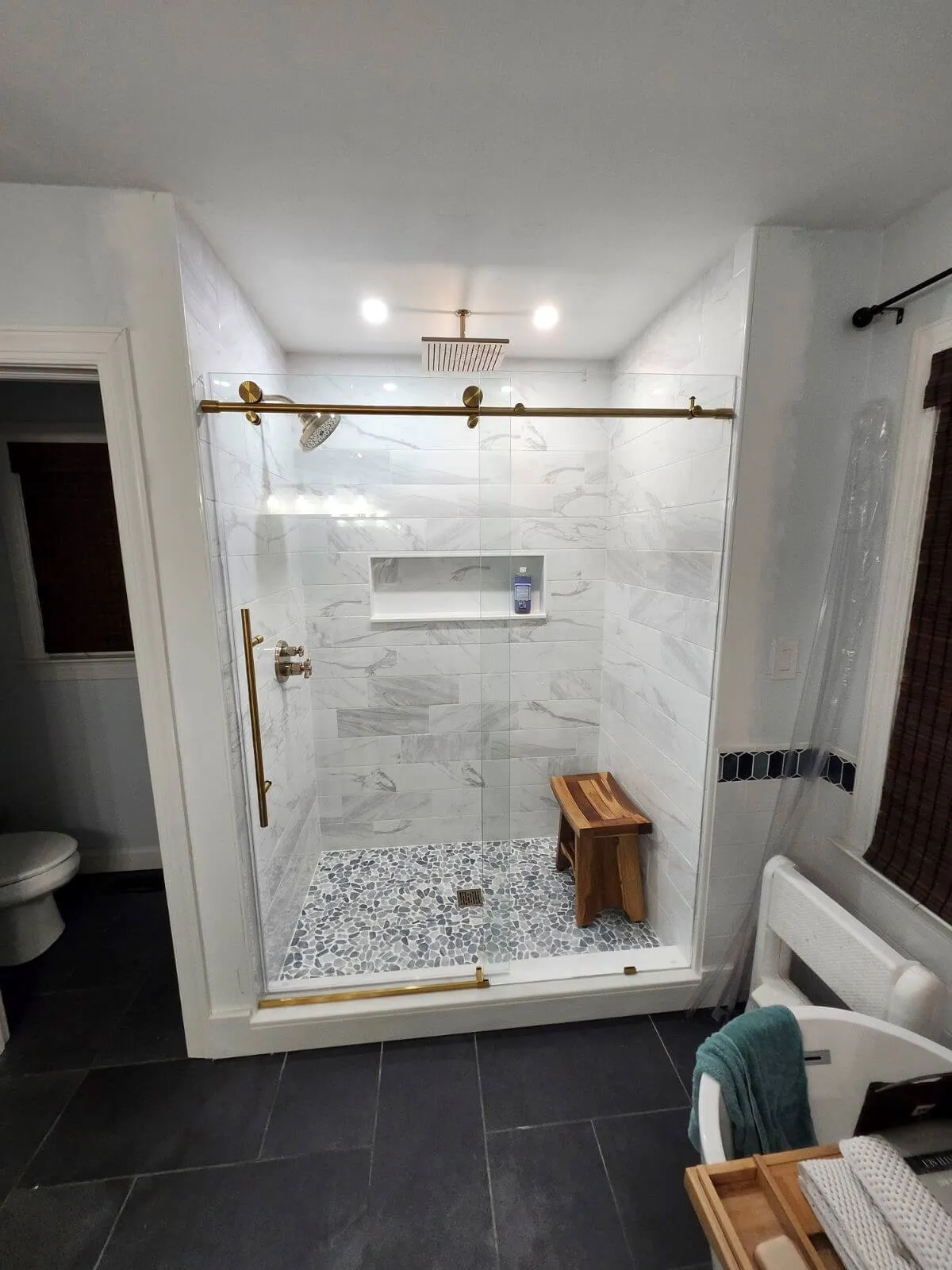 Luxury shower with rain head and tile bench in Chesapeake bathroom