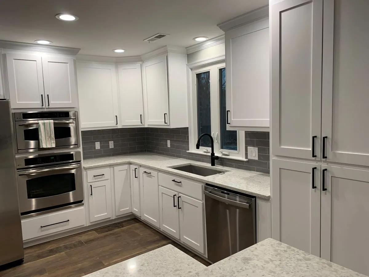 White kitchen with corner cabinets and granite counters