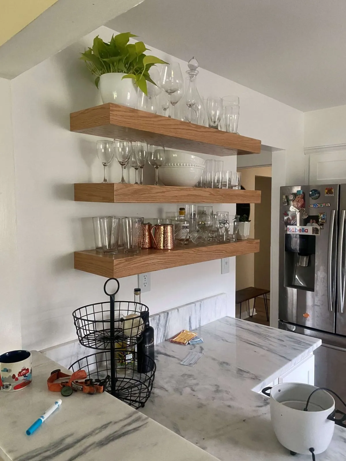 Kitchen remodel with floating wood shelves and white cabinets