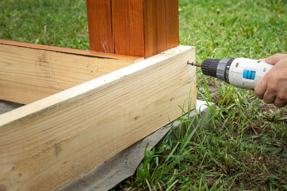 Drill repairing structural joist beam on exterior framing.