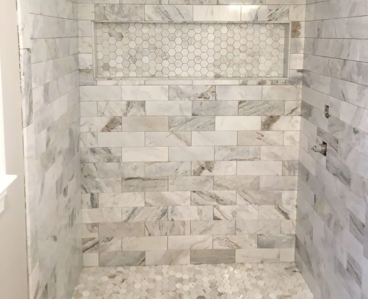 Fully rebuilt walk-in shower with decorative wall tile and glass door done in Chesapeake VA