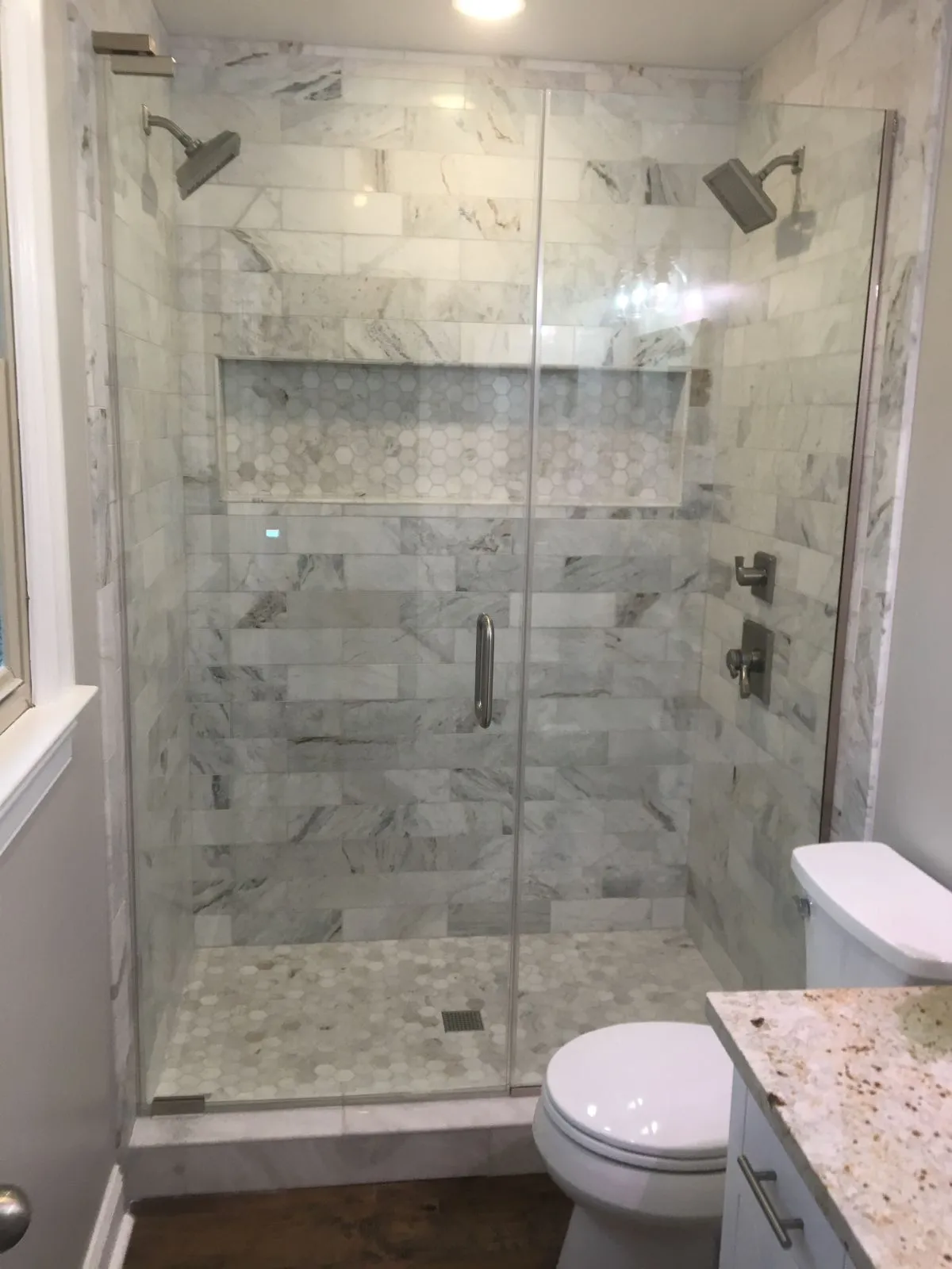 Finished bathroom with marble tile shower, glass doors, and new granite vanity top in Chesapeake