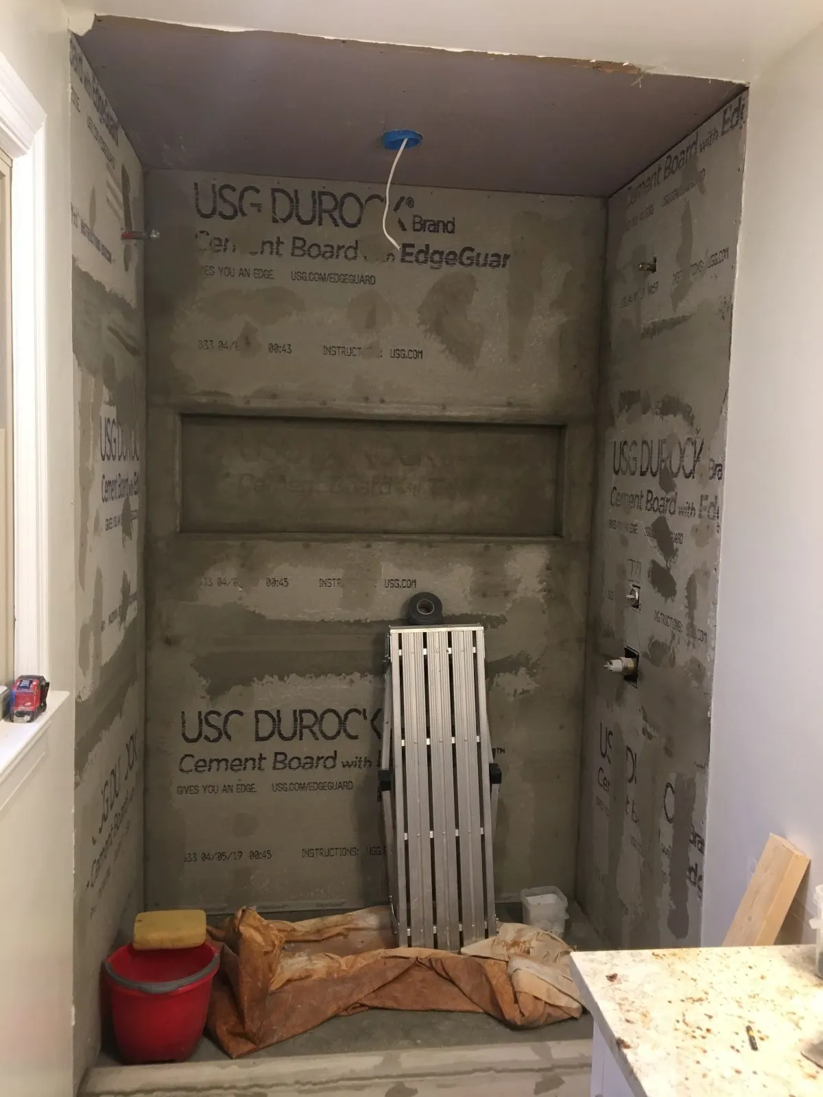 Bathroom walls stripped to cement board during damage evaluation phase